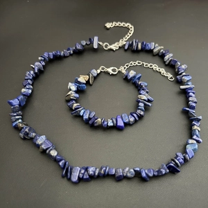 Detail of blue lapis lazuli stone necklace and bracelet set with silver lobster clasp