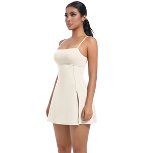 Detail of a white athletic dress featuring slim straps and a stylish side slit design