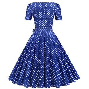 Back view of a French retro blue A-line dress with white polka dots and short sleeves