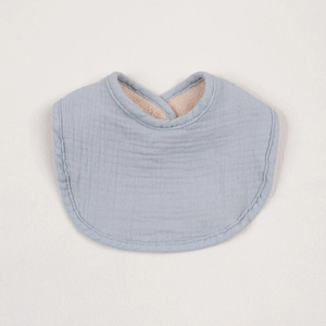 Close-up of baby cotton gauze bib in light blue with soft absorbent lining texture