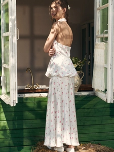 White floral two-piece set featuring a halter backless top and bubble hem long skirt