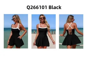 Lace-up back detail and contrasting white straps on a black one-piece swimsuit dress