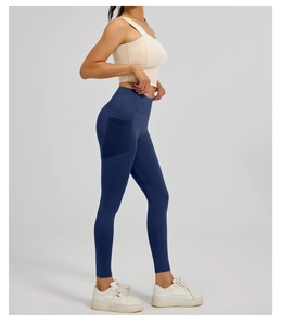 Detail view of high waist yoga leggings in dark blue with functional side pocket