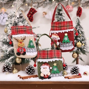 Three festive Christmas burlap gift bags featuring Santa, reindeer, and snowman designs