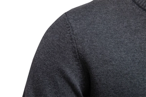 Detail view of the high-quality shoulder stitching on a dark grey knit cardigan sweater