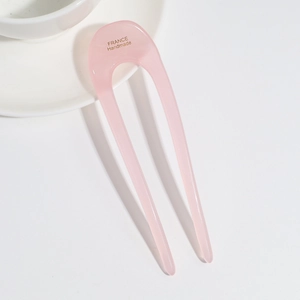Detailed macro view of pink U-shaped hair pin with gold France Handmade engraving