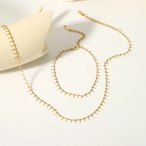 Detailed macro view of 18K gold plated stainless steel fringe chain with lobster clasp