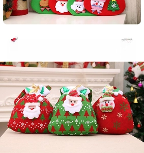Detail of Christmas velvet drawstring gift bags with Santa and snowman embroidery and gold bows