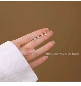 Close-up of S925 sterling silver bow earrings featuring sparkling cubic zirconia studs