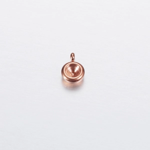 Macro shot of rose gold round stainless steel pendant setting with a central hollow