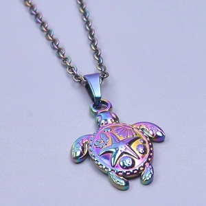 Macro shot of iridescent sea turtle pendant with starfish and shell embossed details