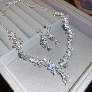Sparkling diamond-set flower and teardrop necklace and earrings jewelry set in display box
