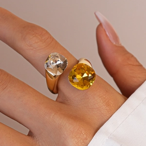Detailed close-up of open ring with large clear and yellow square crystals on gold band