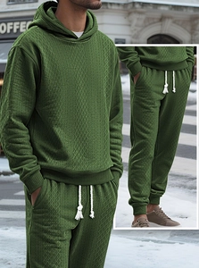 Detail showing olive green knit tracksuit texture with 3D diamond pattern and drawstring