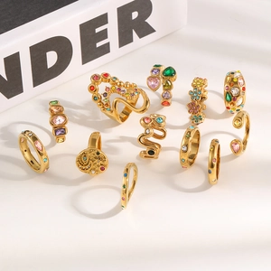 Detailed macro shot of multi-style 18K gold plated rings with colorful rhinestones