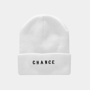 Close-up of black 'CHANCE' embroidery on white ribbed knit beanie for street fashion