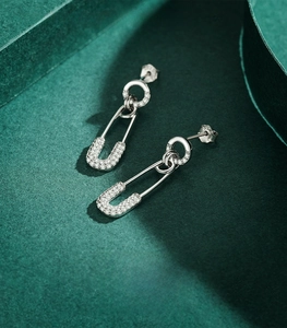 Macro view of 925 sterling silver safety pin earrings with pave cubic zirconia stones