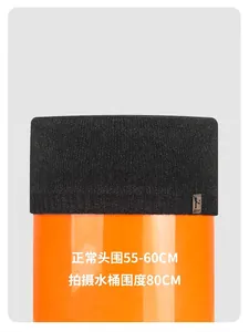 Detail showing highly elastic black knit beanie stretched to demonstrate flexible fit
