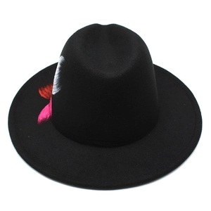 Detail of wide brim black felt fedora hat with red and silver spray painted feathers