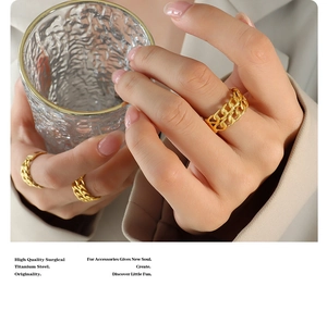 Detail of gold double-layer chain ring in titanium steel worn with modern attire