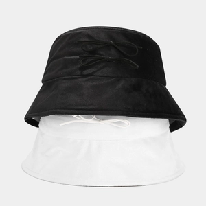 Minimalist vintage suede bucket hat with bow detail in black and white colors