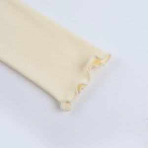 Detail shot of cream long sleeve top featuring delicate lettuce edge cuffs and knit texture