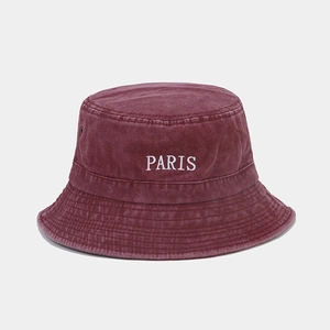 Detail of burgundy washed cotton bucket hat featuring white PARIS embroidery and vent holes