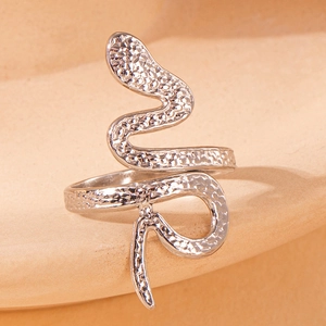 Close-up of silver snake-shaped open ring with unique hammered metal texture detail