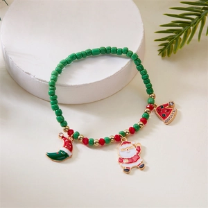 Detail of Christmas beaded bracelet with Santa Claus and festive charms on white stone