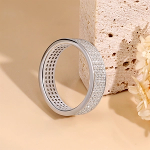 Luxurious 925 sterling silver moissanite ring with three rows of pavé diamonds on a stone base