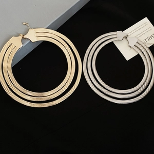 Close-up of triple-layered spring snake chains in gold and silver finish with smile card