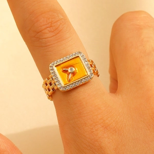 Gold chain ring with square yellow enamel face and crystal key detail on the top