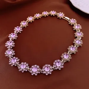 Luxurious purple crystal floral necklace with golden flower clusters on silk background