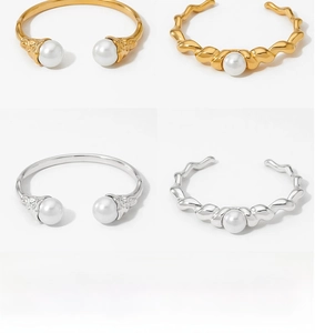 Detail view of gold and silver irregular twist bangles with white pearl accents