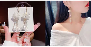 Detail of S925 silver needle pearl tassel earrings showing the white flower and long fringe