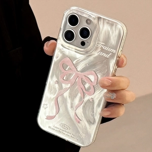 Macro detail of dopamine pink bow and Traum Land text on a textured white phone case