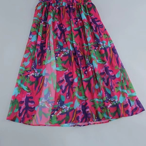 Detailed view of the tropical floral print and side slit on the chiffon summer dress