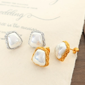 Vintage irregular pearl studs with silver and gold metal borders in a romantic setting