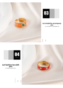 Detail of adjustable gold-plated enamel rings with malachite and crystals on silk
