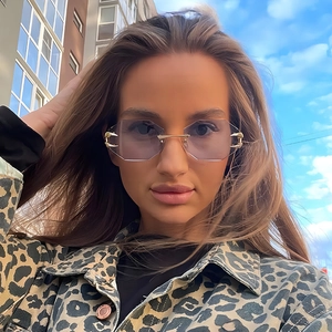Frameless octagonal sunglasses with purple gradient lenses and golden leopard claw metal accents