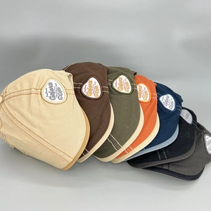 Detailed close-up of retro beret hats showing various color options and cotton twill texture