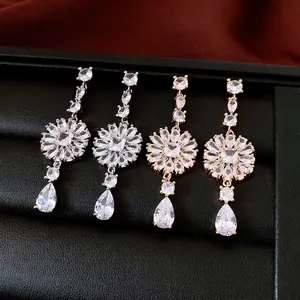 Elegant french style sunburst silver needle earrings with pear-cut cubic zirconia drops