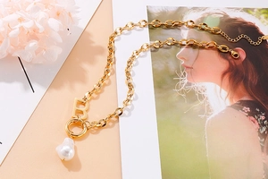 Detail of gold B letter pendant with baroque pearl on thick O-chain necklace