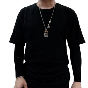 Retro titanium steel necklace with turquoise eagle claw feather pendants on male model