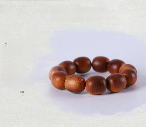 Close-up of aged Thuja sutchuenensis wood beads showing natural grain and texture