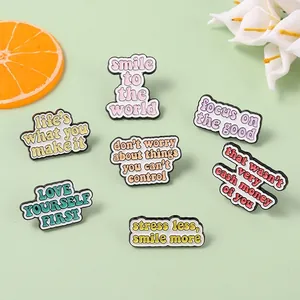 Set of 7 colorful enamel pins with motivational English quotes on green background