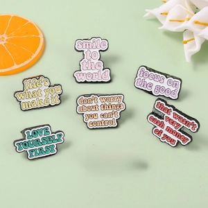 Set of 7 colorful enamel pins with motivational English quotes on green background