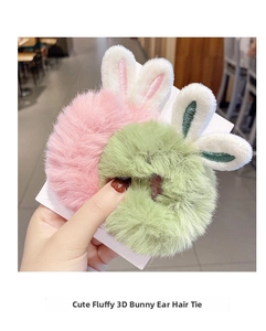 Close-up of pink and green plush bunny ear hair ties with soft faux fur texture