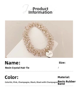 Detail view of champagne resin crystal hair tie with LUNA engraved metal charm