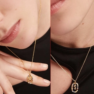 Gold pendant necklace with M and S letters featuring colorful crystal gemstones